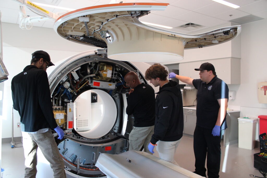 Request a Quote for radiology equipment service as technicians inspect and maintain advanced imaging system for optimal performance